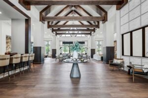 Luxurious modern interior with wooden beams, stylish decor, and natural lighting in a spacious living area.